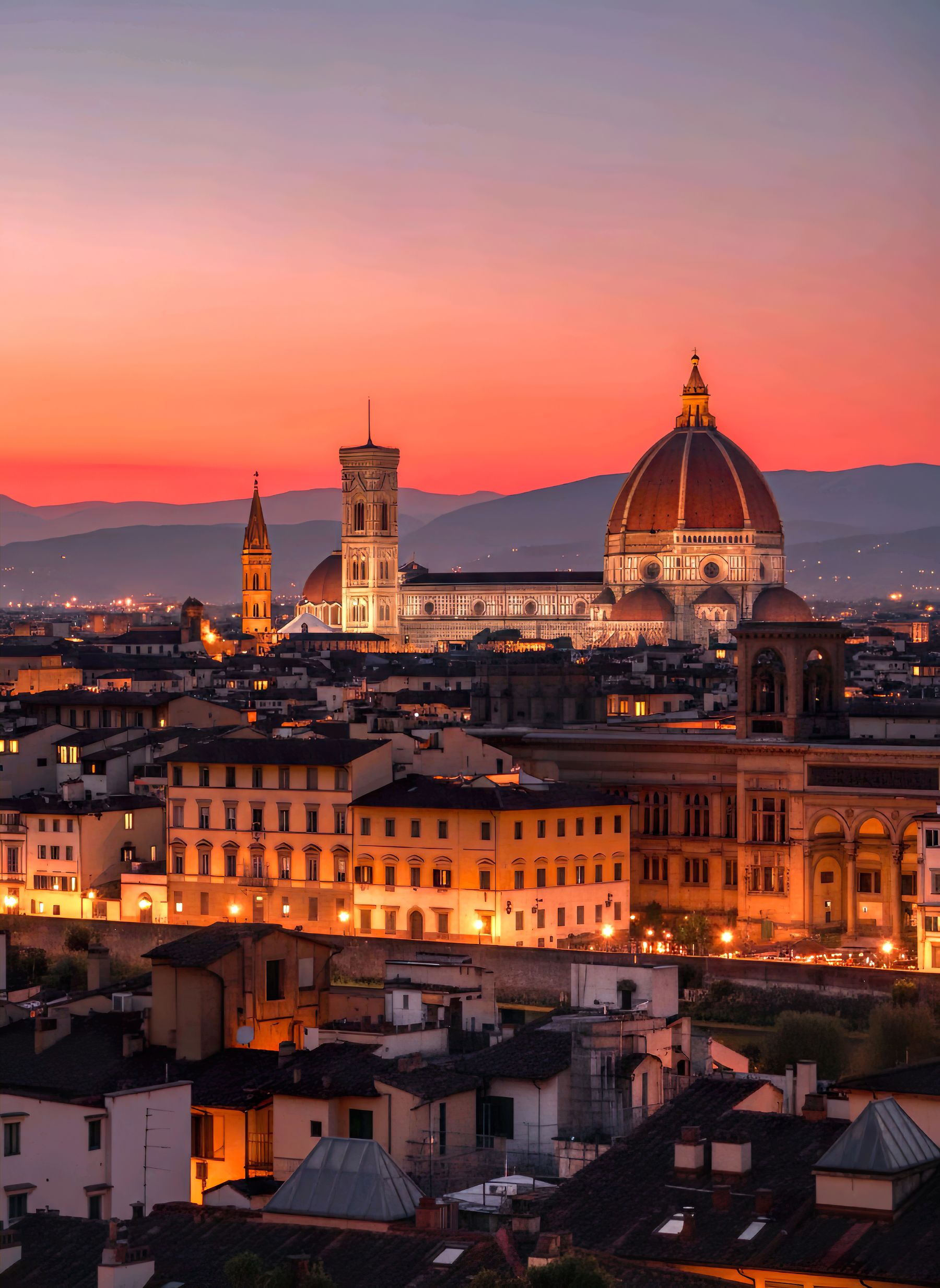 Florence's Duomo and Giotto's bell tower above the rooftops at sunset